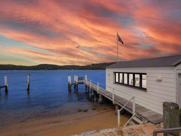 Bespoke deep waterfront haven with private beach and boatshed