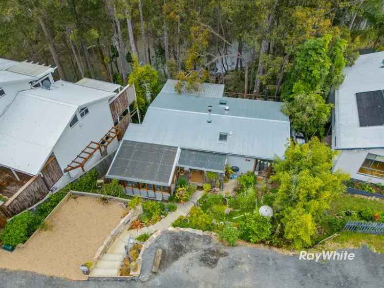 Buy cottage in Moruya Heads with lush garden and river access