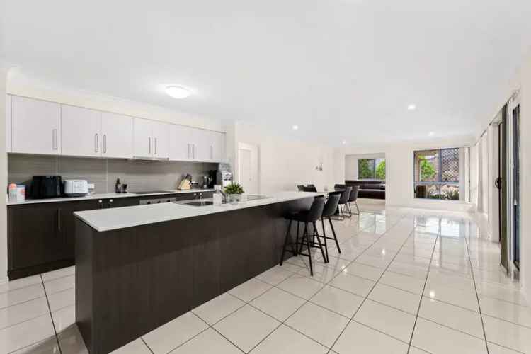 Massive, modern family home with multiple living spaces, a huge backyard & back onto the bushlands!