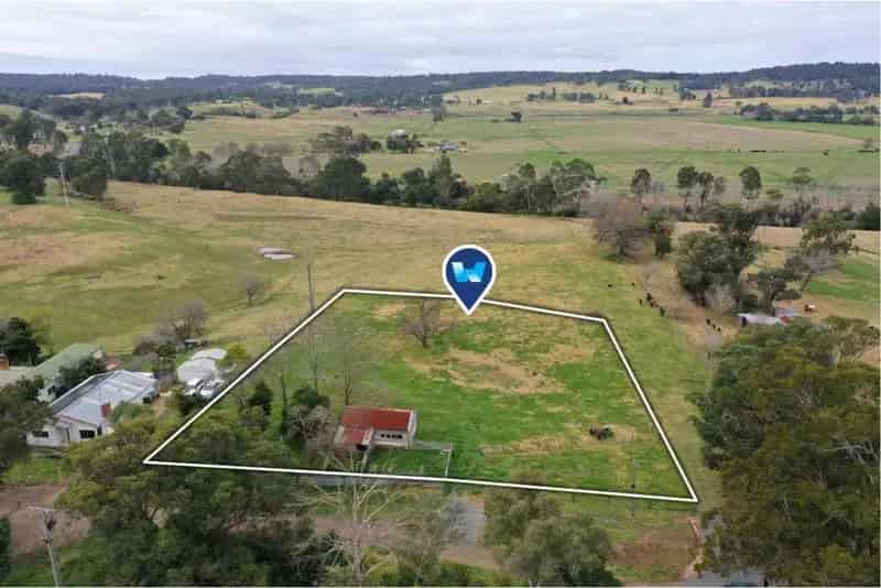 Buy rural property in Sarsfield with old milking shed and town utilities