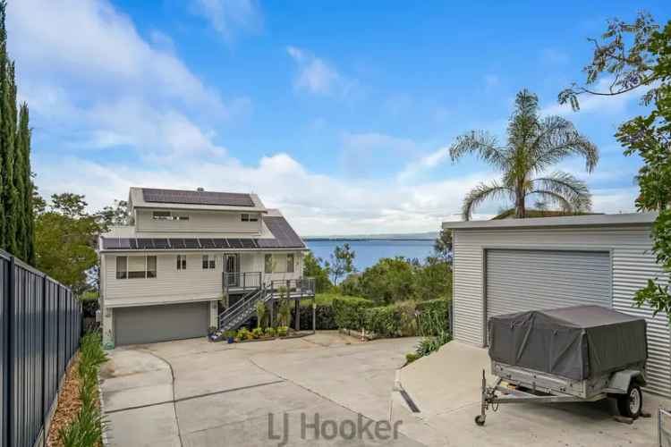 Buy tri-level home lakeside at Lake Macquarie with stunning views and features