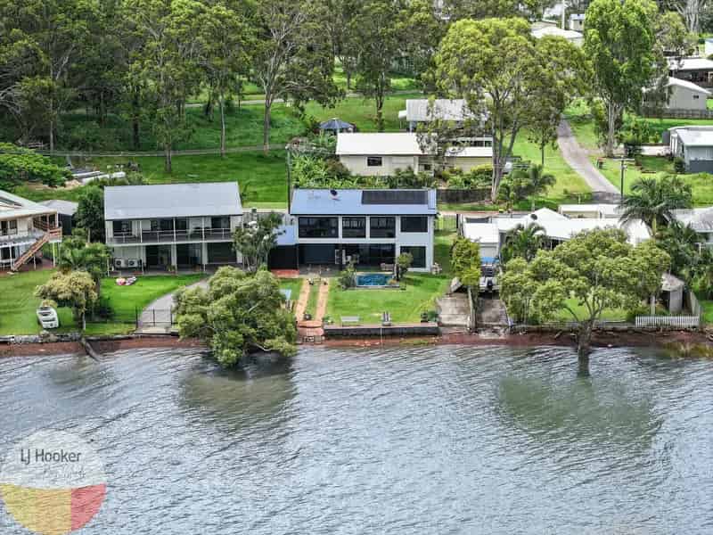 Buy stunning two-story waterfront home with pool and modern features