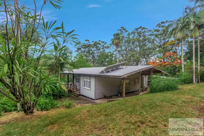 Buy rural property in serene 106 acres with charming home and creek