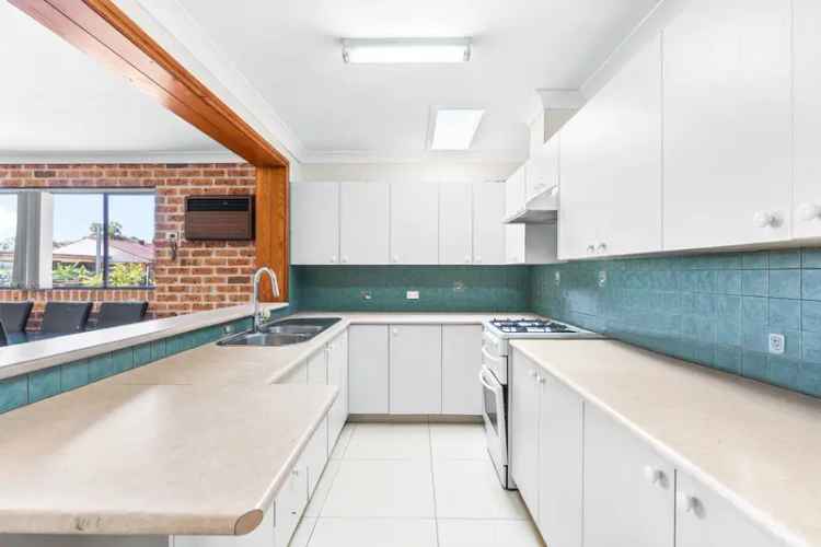 Buy Family Home in St Johns Park with Spacious Living and Pool