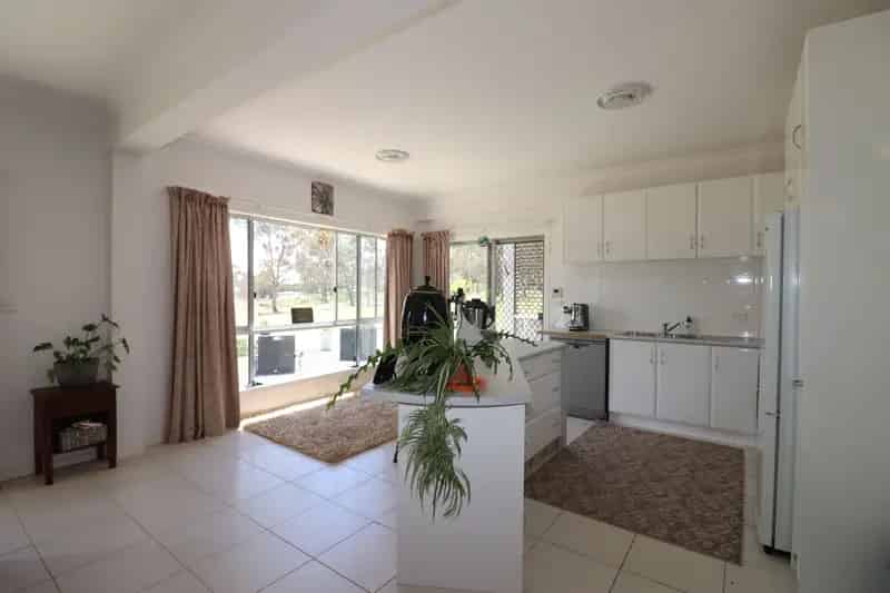 Buy acreage home in town with extensive living space and amenities