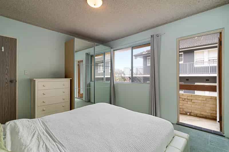 Spacious boutique apartment with leafy outlook & two balconies in a prime beachside location
