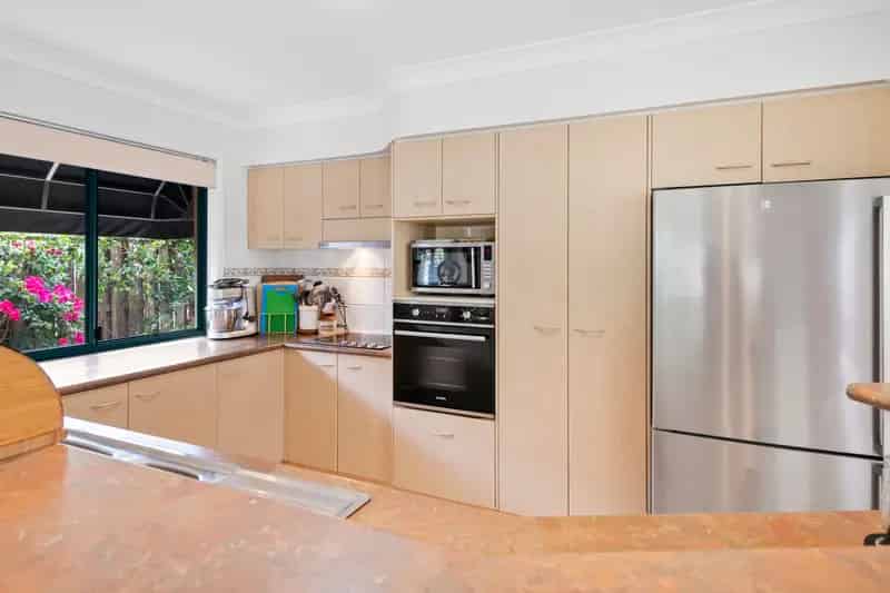 Buy house in Coombabah with serene waterside views and modern features